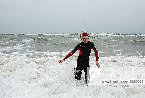 Boy cold water swimming in winter in the sea