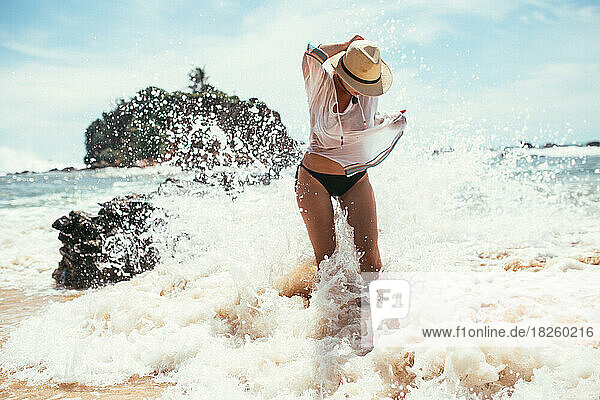 a beautiful girl washes away with a wave