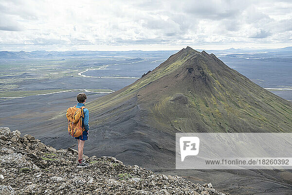A boy hikes on a mountain in the north of Iceland
