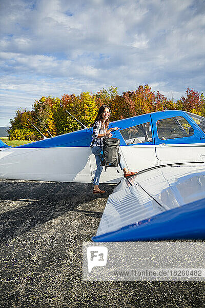 Young BIPOC Female Pilot preparing to travel by small airplane