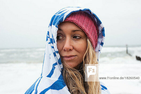 portrait of woman in a towel after cold water swimming in the sea