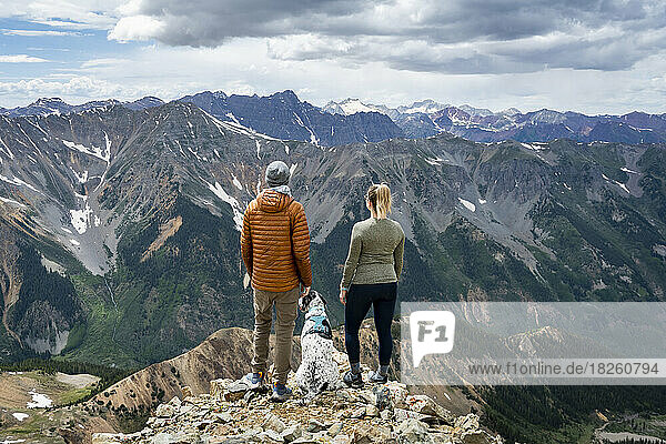 Couple looking at view while hiking with dog at Electric Pass