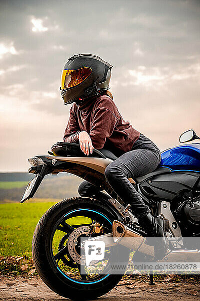 Motorbike girl posing with her thoughts