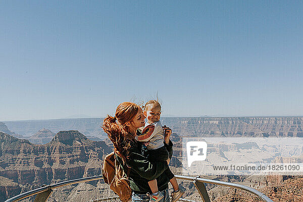Redhead mother and daughter standing outside by the North Rim of
