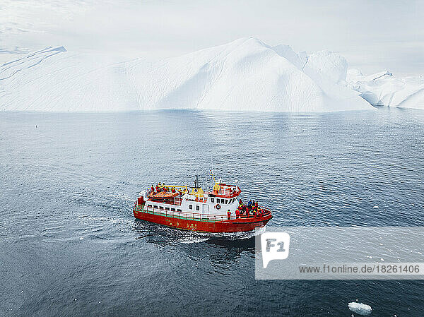 boat near big icebergs from aerial point of view