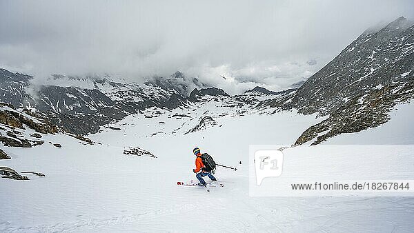 Skiers skiing downhill on the Sommerwandferner glacier  Stubai Alps  Tyrol  Austria  Europe