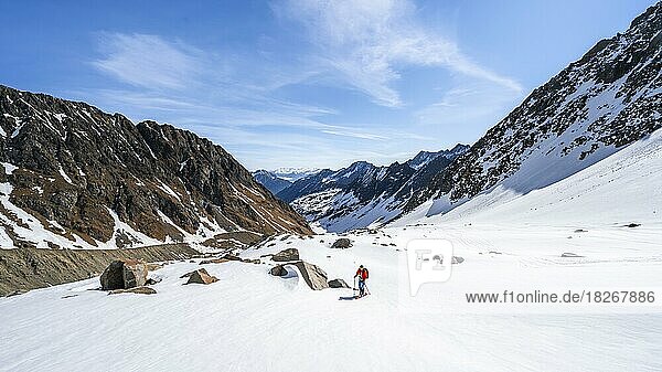 Ski tourers ascending along the glacier moraine to Berglasferner  Berglastal  Stubai Alps  Tyrol  Austria  Europe