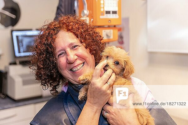 Veterinary clinic  portrait of a female veterinarian with a small dog