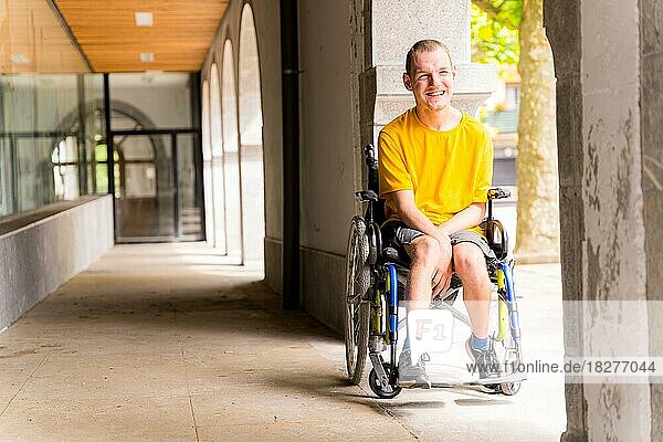 Portrait of a disabled person in a wheelchair smiling next to some columns in a doorway