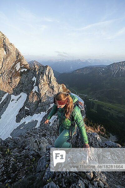 Evening atmosphere  mountaineer climbing on the summit of Schartschrofen  behind Rote Flüh  Tannheimer Bergen  Allgäu Alps  Tyrol  Austria  Europe