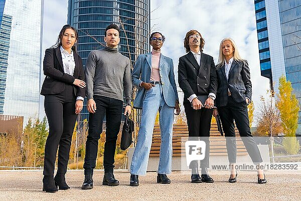 Corporate portrait of group of multi-ethnic businessmen and businesswomen outside offices