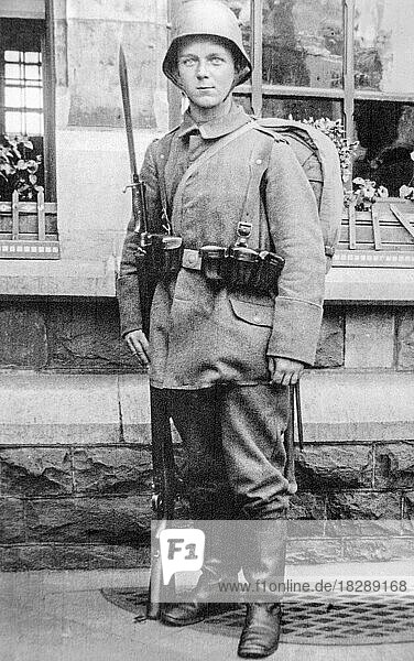Young German WWI Bavarian infantry soldier  infantryman posing in battledress with rifle  bayonet and stahlhelm in 1917 during First World War One