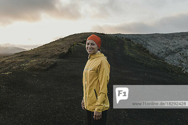 Smiling woman standing at Caldera Blanca volcano  Lanzarote  Canary Islands  Spain
