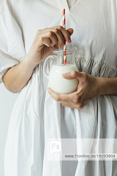 Woman holding jar of milkshake