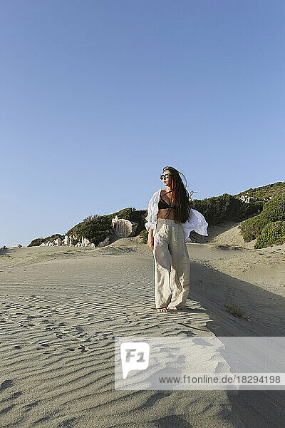 Young woman standing on sand at beach  Patara  Turkiye