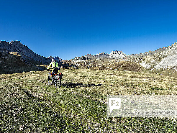 Senior man riding mountain bike on pathway  Vanoise National Park  France