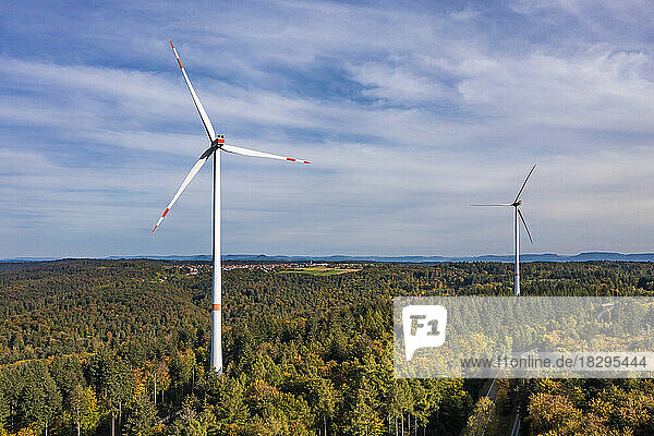 Germany  Baden-Wurttemberg  Aerial view of wind farm surrounded by autumn forest