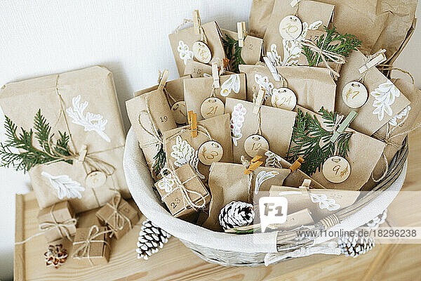 Decorated paper bags prepared for advent calendar and kept in basket