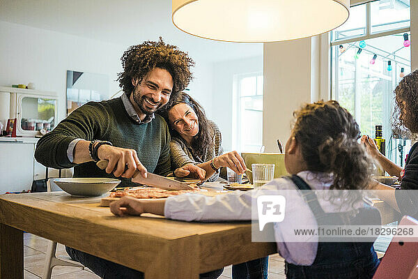 Happy family having lunch together on dining table at home