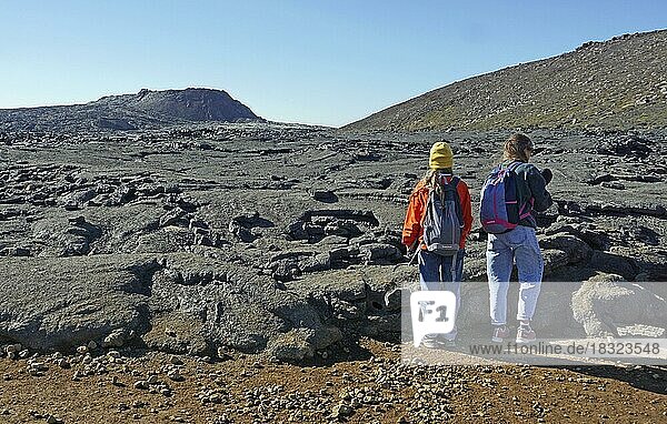Women hikers standing in front of solidified lava  Fagradalsfjall  Reykjanes  Grindavik  Iceland  Europe