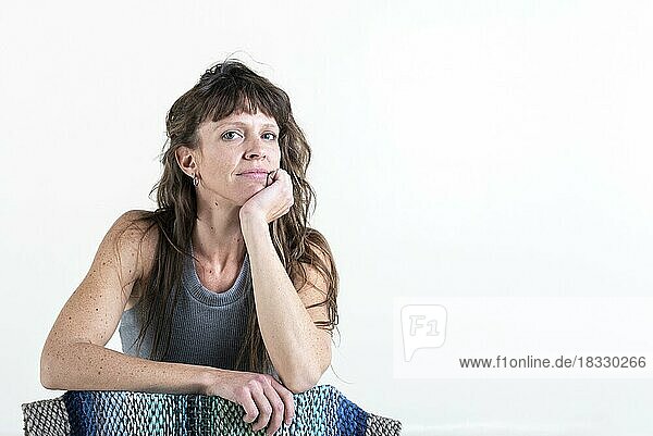 Beautiful woman looking at camera over a white background. Copy space. Studio Shot
