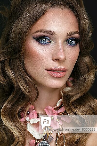 Beautiful girl with bright fashionable make-up and unusual pink accessories. Beauty face. Photo taken in the studio