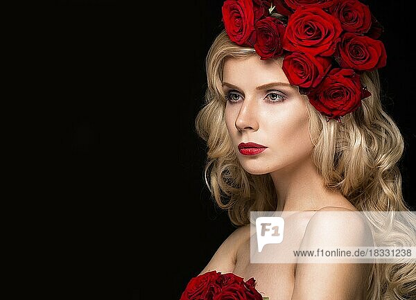 Beautiful blond girl in a dress and hat with roses  classic makeup  curls and red lips. Beauty face. Photos shot in studio