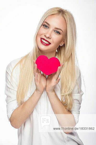 Love and valentines day  woman holding hearts smiling cute. Portrait of Beautiful woman with bright makeup and red heart in hand