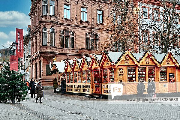Heidelberg  Germany  September 2019: Big sales booth in small wooden sheds as part of traditional Christmas market on university square in city center of Heidelberg  Europe