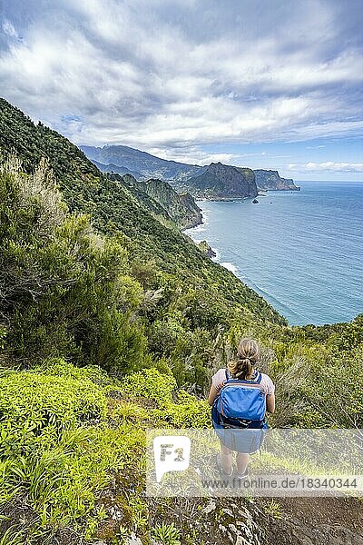 Hiker on the Vereda do Larano trail  view of cliffs  coastal landscape and sea  Madeira  Portugal  Europe