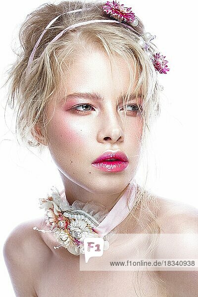 Beautiful blond fashion girl with flowers on the neck and in her hair  wet Nude makeup. Beauty face. Photos shot in the studio