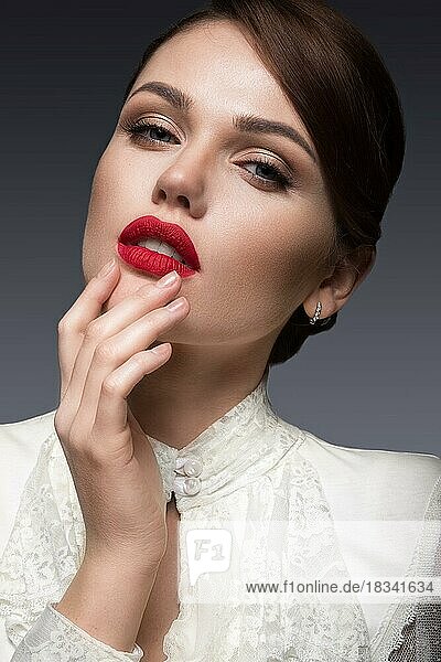 Beautiful girl with red lips in white clothes in the form of retro. Beauty face. Picture taken in the studio