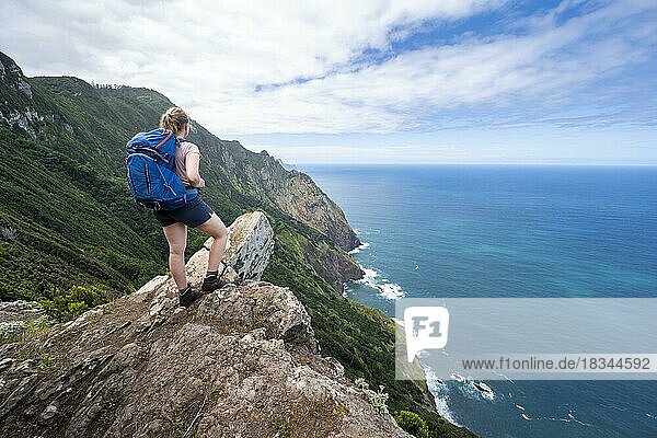 Hiker on the ridge of Pico do Alto  view of cliffs  coastal landscape and sea  Madeira  Portugal  Europe