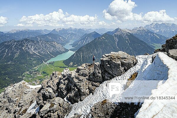 Hiker looking down from Thaneller to Plansee and eastern Lechtal Alps  Tyrol  Austria  Europe