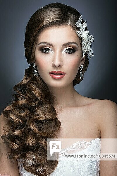 Portrait of a beautiful woman in the image of the bride accessory. Picture taken in the studio on a black background