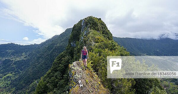Hiker on the ridge of Pico do Alto  Steep Cliffs  Madeira  Portugal  Europe