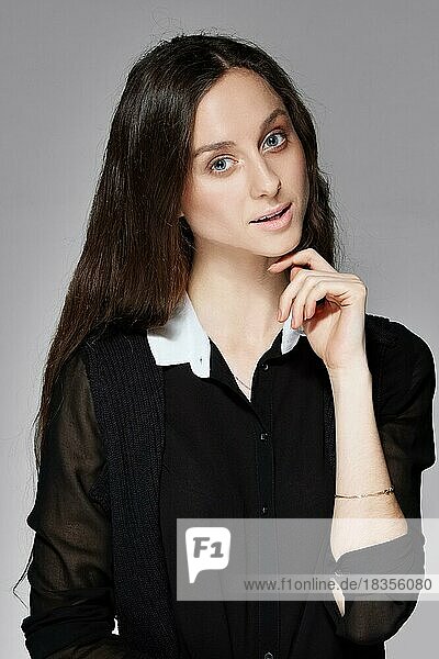Portrait of a pretty girl with natural make up in black blouse with white collar