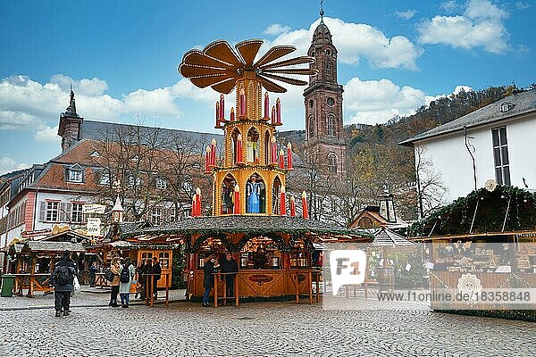 Heidelberg  Germany  September 2019: Massive holiday pyramid with candles as part of traditional Christmas market on university square in city center of Heidelberg  Europe