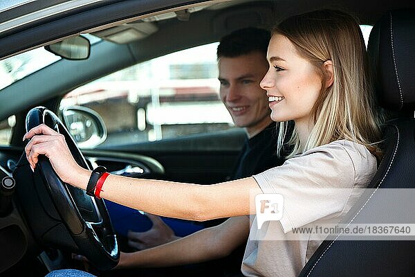 The driver is an auto school instructor and a female student on an examination car. Lesson at the circuit