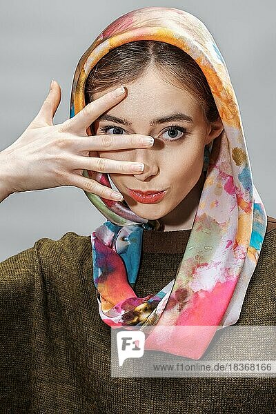 Tricky lady posing in colorful silk scarf