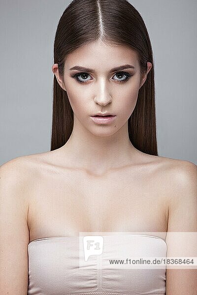 Beautiful young girl with a light natural make-up. Beauty face. Picture taken in the studio