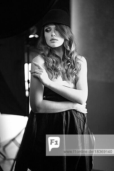 Schönes Mädchen posiert bei einem Fotoshooting im Studio. Schwarz-Weiß-Bild