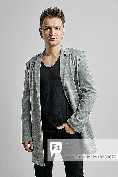 Portrait of a handsome man wearing wool jacket  black shirt and jeans