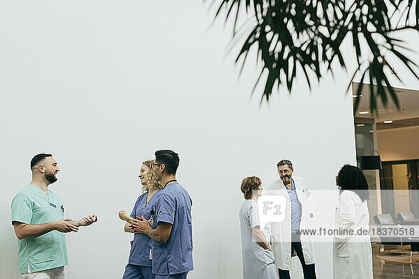 Ein Team aus männlichen und weiblichen Mitarbeitern des Gesundheitswesens bespricht sich im Krankenhaus