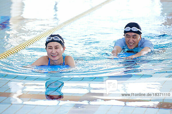 Japanese senior couple at indoor swimming pool