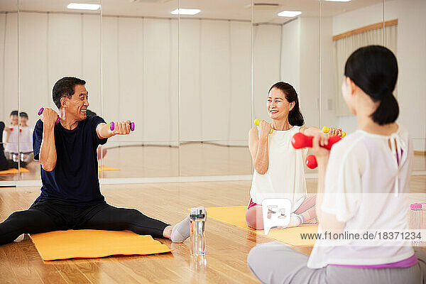 Japanese senior couple training at indoor gym