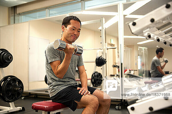 Japanese man training at indoor gym