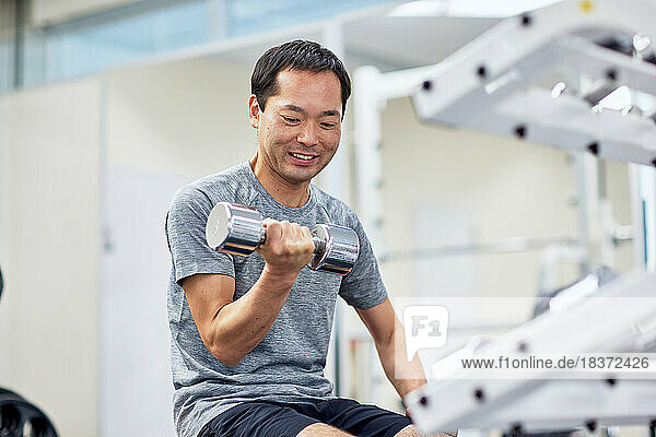 Japanese man training at indoor gym