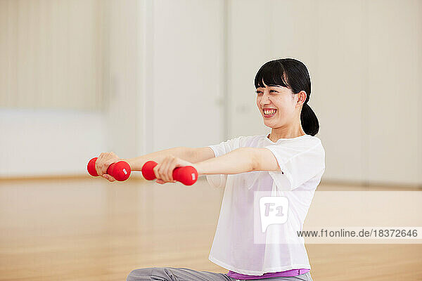 Japanese senior woman training at indoor gym
