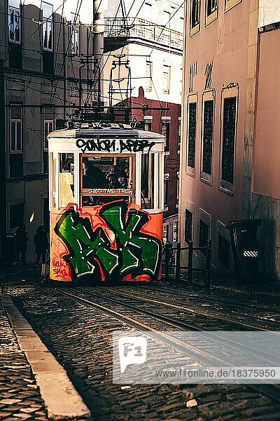 House fronts  narrow streets  alleys and stairs  in a historic old town. beautiful urban place Mercês in the morning with tram or also called lift in the capital Lisbon  Portugal  Europe